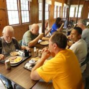 Photo of men sharing a meal together
